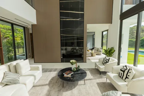 a living room with furniture and a floor to ceiling window