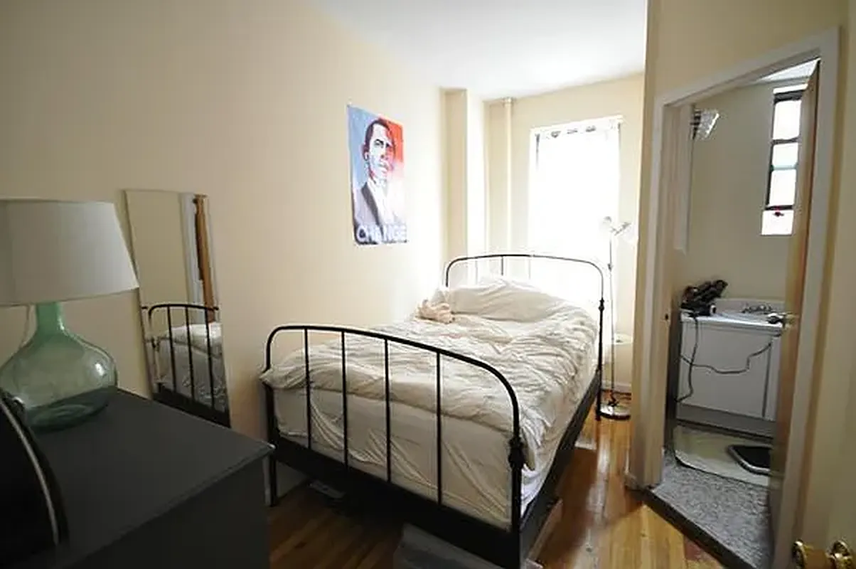 416 East 71st Street, Unit 21 Manhattan, NY 10021 - Photo 4 of 5 a bedroom with a bed and wooden floor