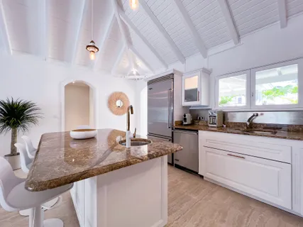 a kitchen with granite countertop a stove a sink and a granite counter tops
