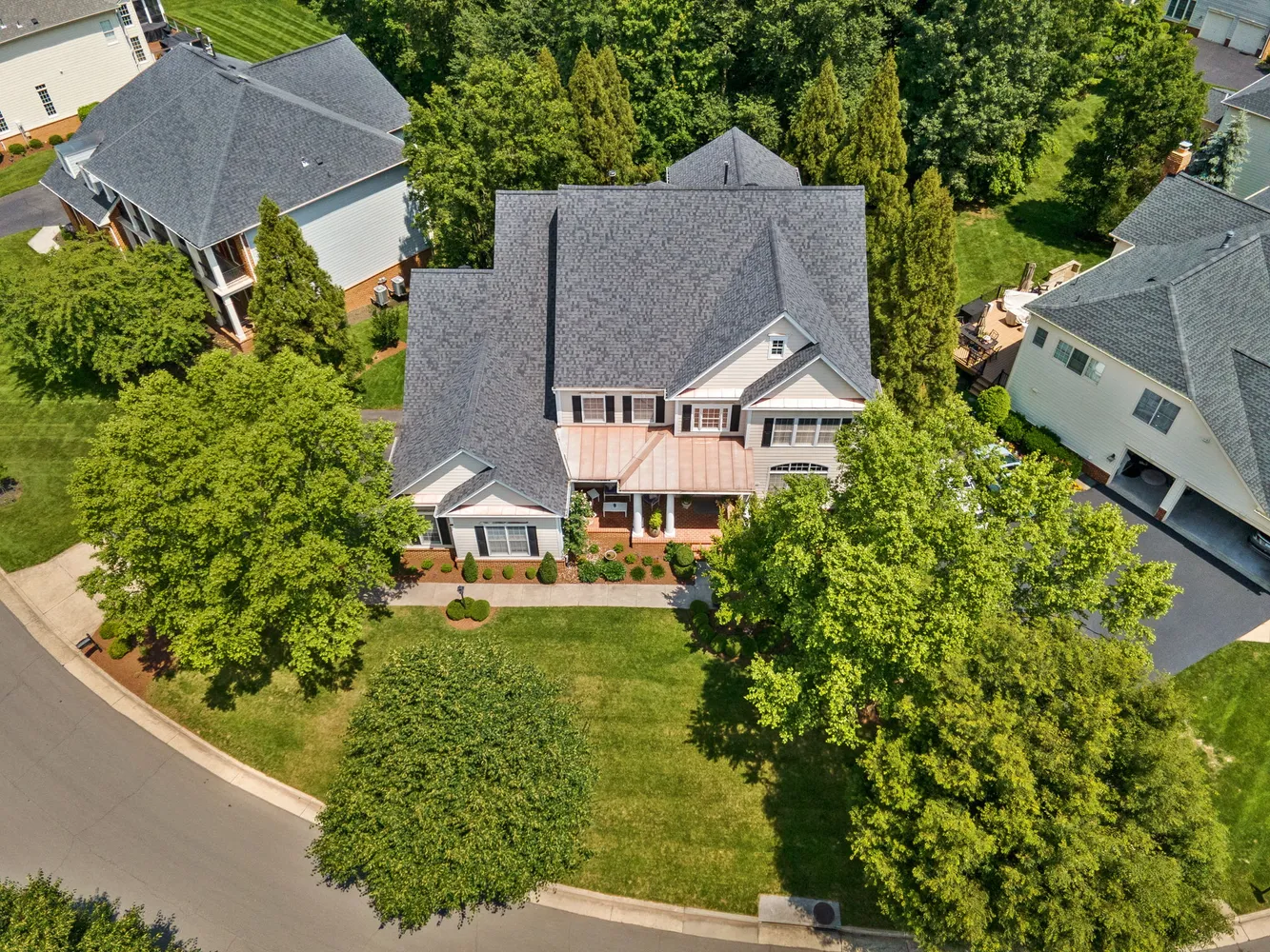 an aerial view of residential houses with outdoor space and street view