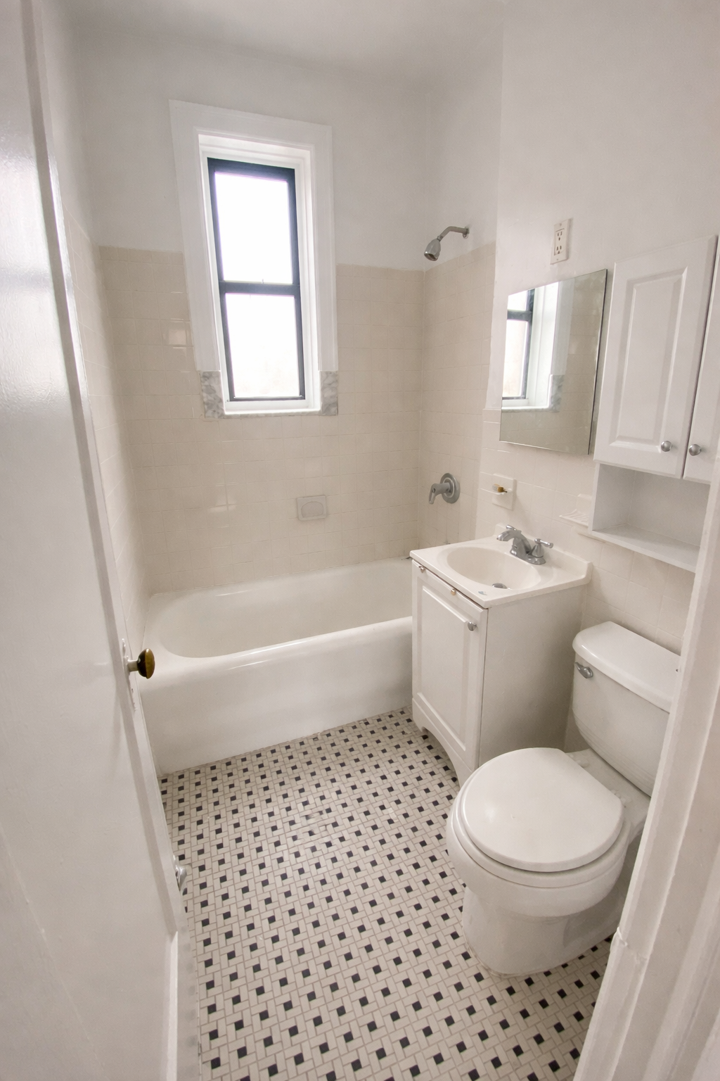 28-23 42nd Street, Unit D5 Queens, NY 11103 - Photo 10 of 10 a bathroom with a toilet a sink and a bath tub