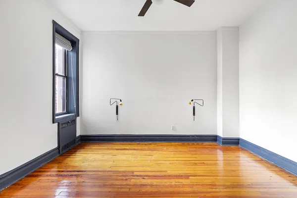 a view of a room with wooden floor and