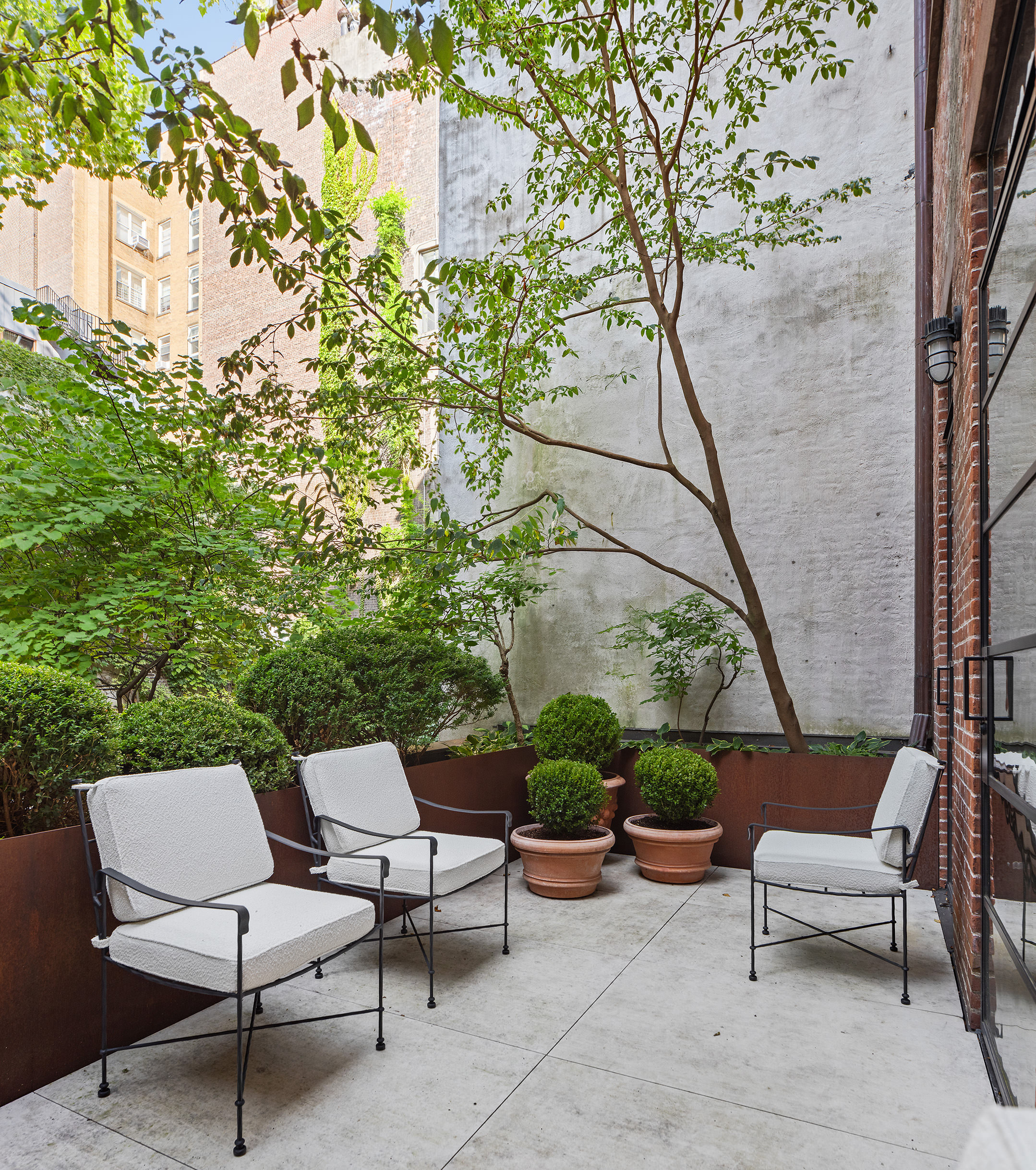 55 West 9th Street Manhattan, NY 10011 - Photo 9 of 20 a view of backyard with outdoor seating and plants