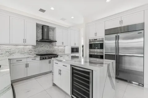a kitchen with cabinets stainless steel appliances and a counter space