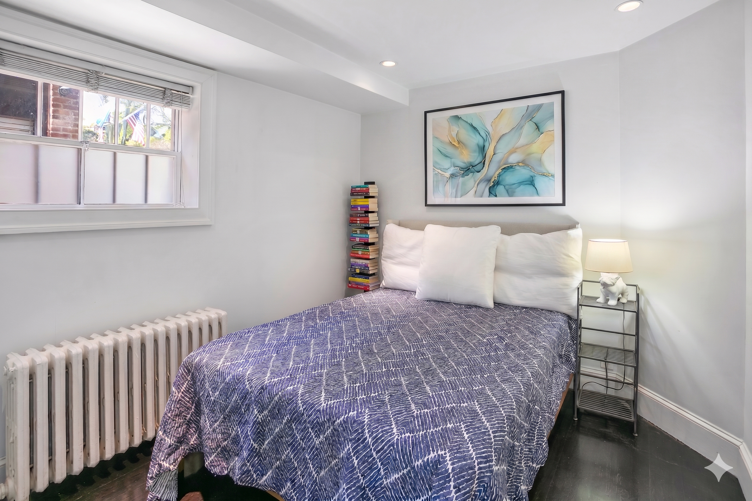 1832 Corcoran Street Northwest Washington, DC 20009 - Photo 20 of 29 a bedroom with a bed and a painting on the wall