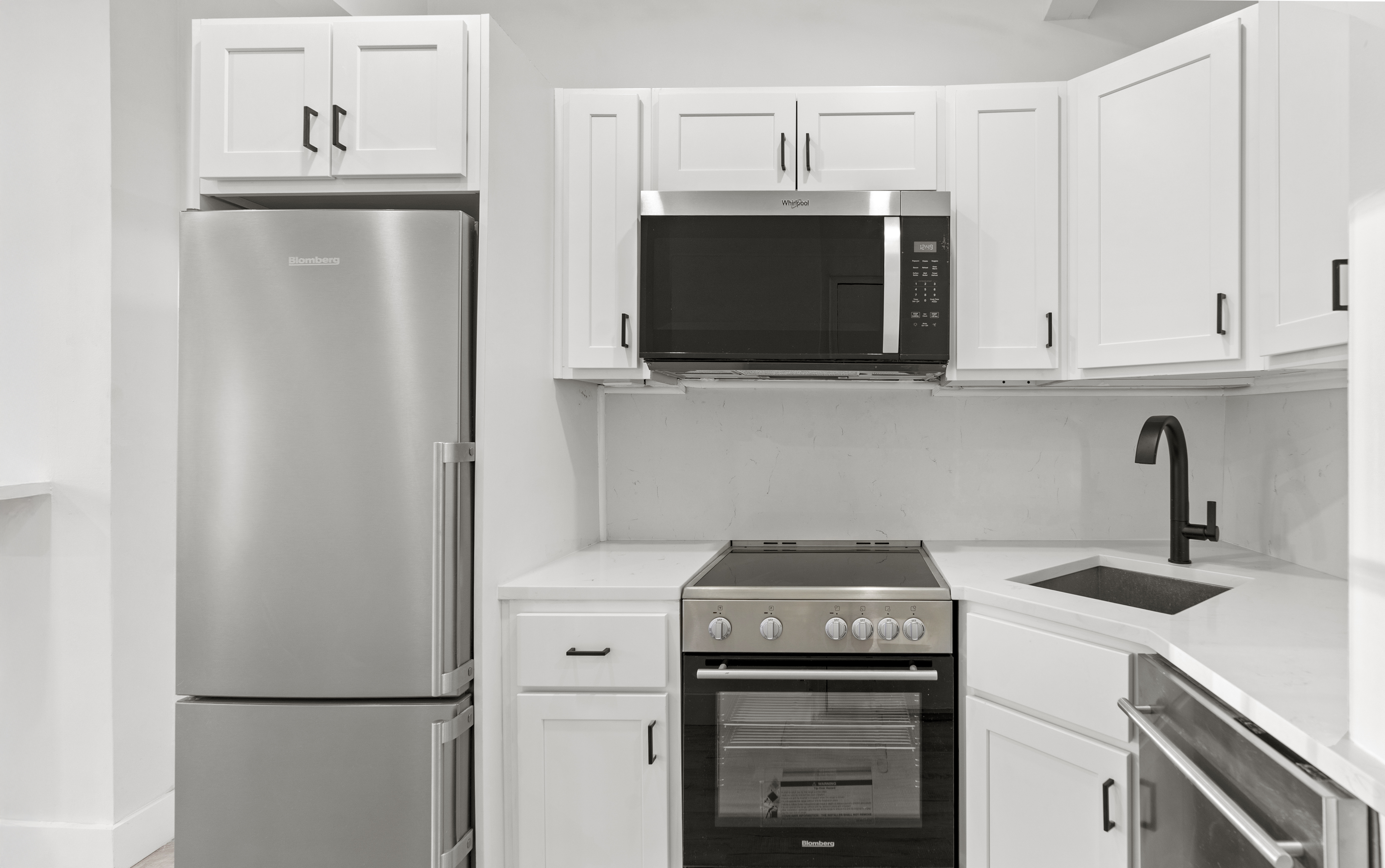 714 Greenwich Street, Unit 8 Manhattan, NY 10014 - Photo 3 of 7 a kitchen with a stove and a microwave