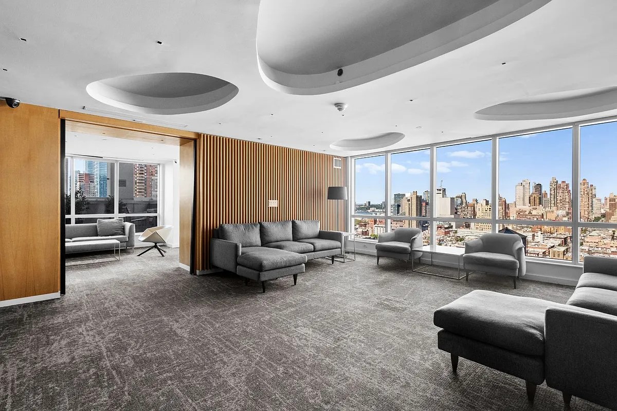 350 West 42nd Street, Unit 12C Manhattan, NY 10036 - Photo 14 of 21 a living room with furniture and a large window