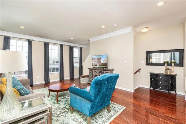 a living room with furniture and a wooden floor