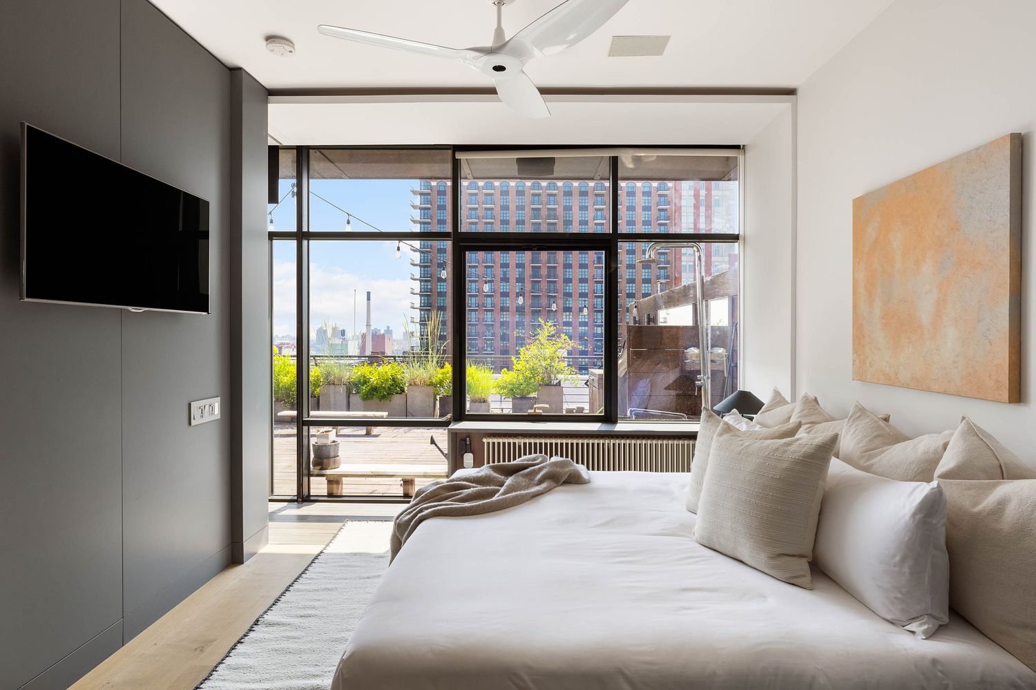 a living room with furniture tv and large window