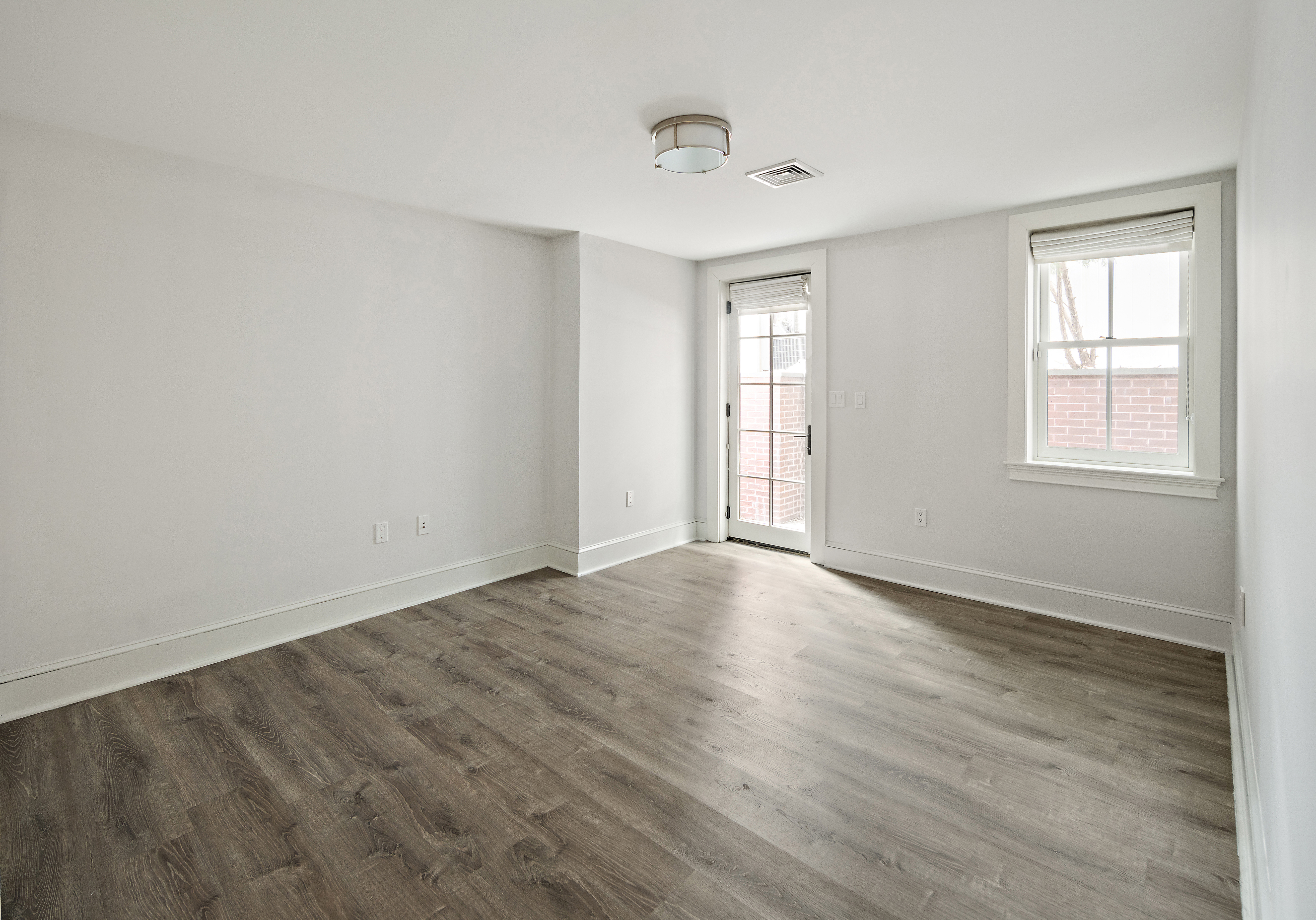 35 Willard Street Cambridge, MA 02138 - Photo 27 of 36 an empty room with wooden floor and windows
