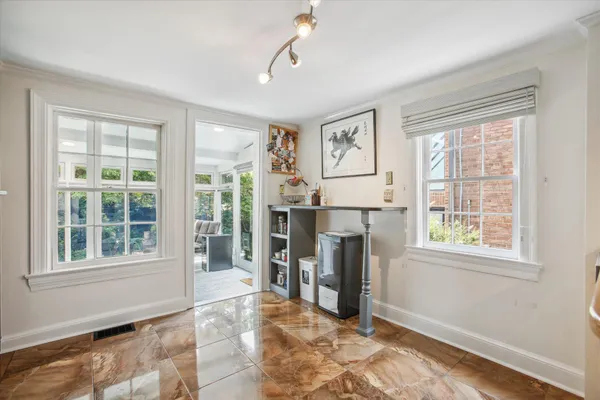 a view of livingroom with furniture workspace and a window