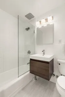 a bathroom with a sink mirror vanity and toilet