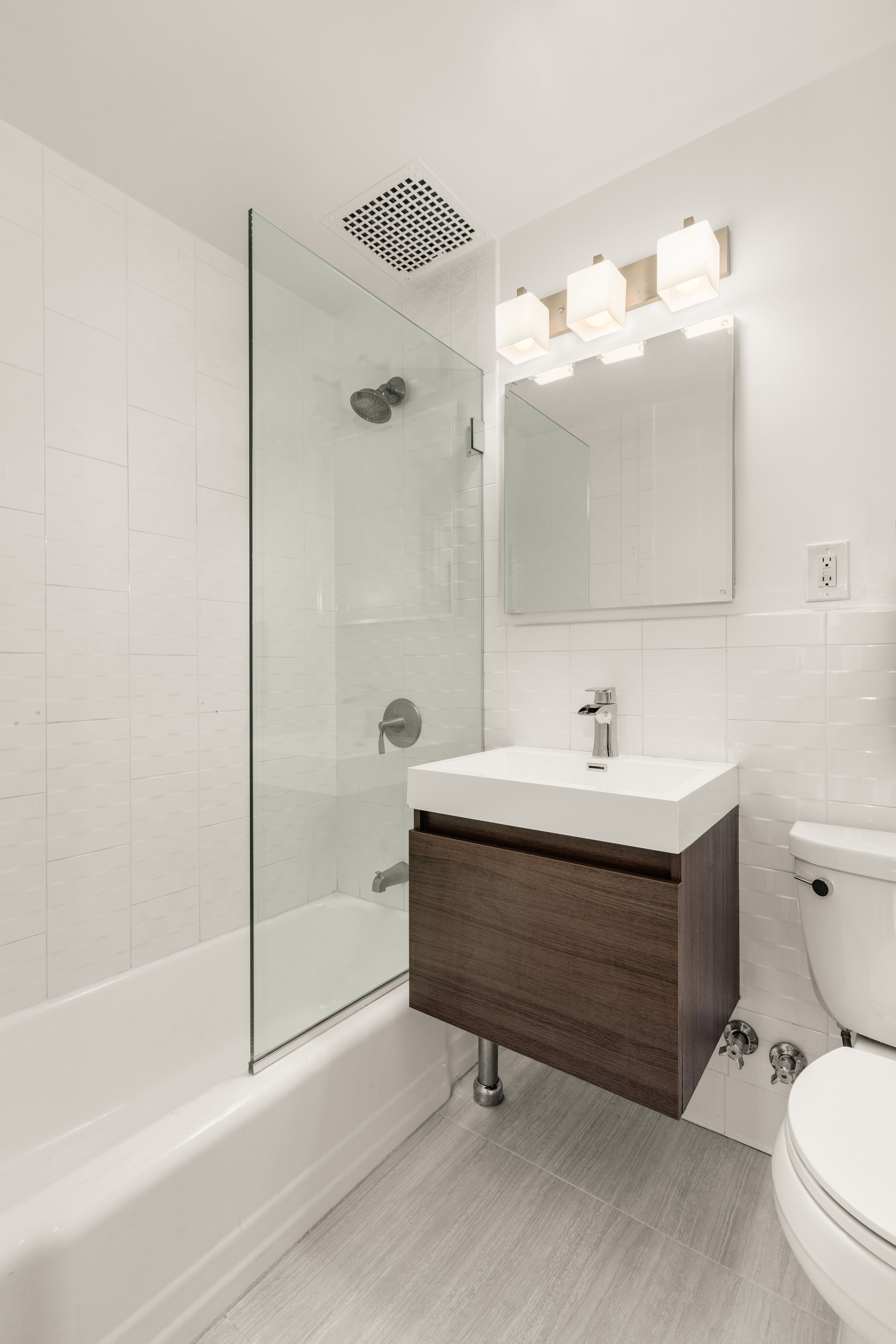 111 East 36th Street, Unit 4A Manhattan, NY 10016 - Photo 12 of 19 a bathroom with a sink mirror vanity and toilet