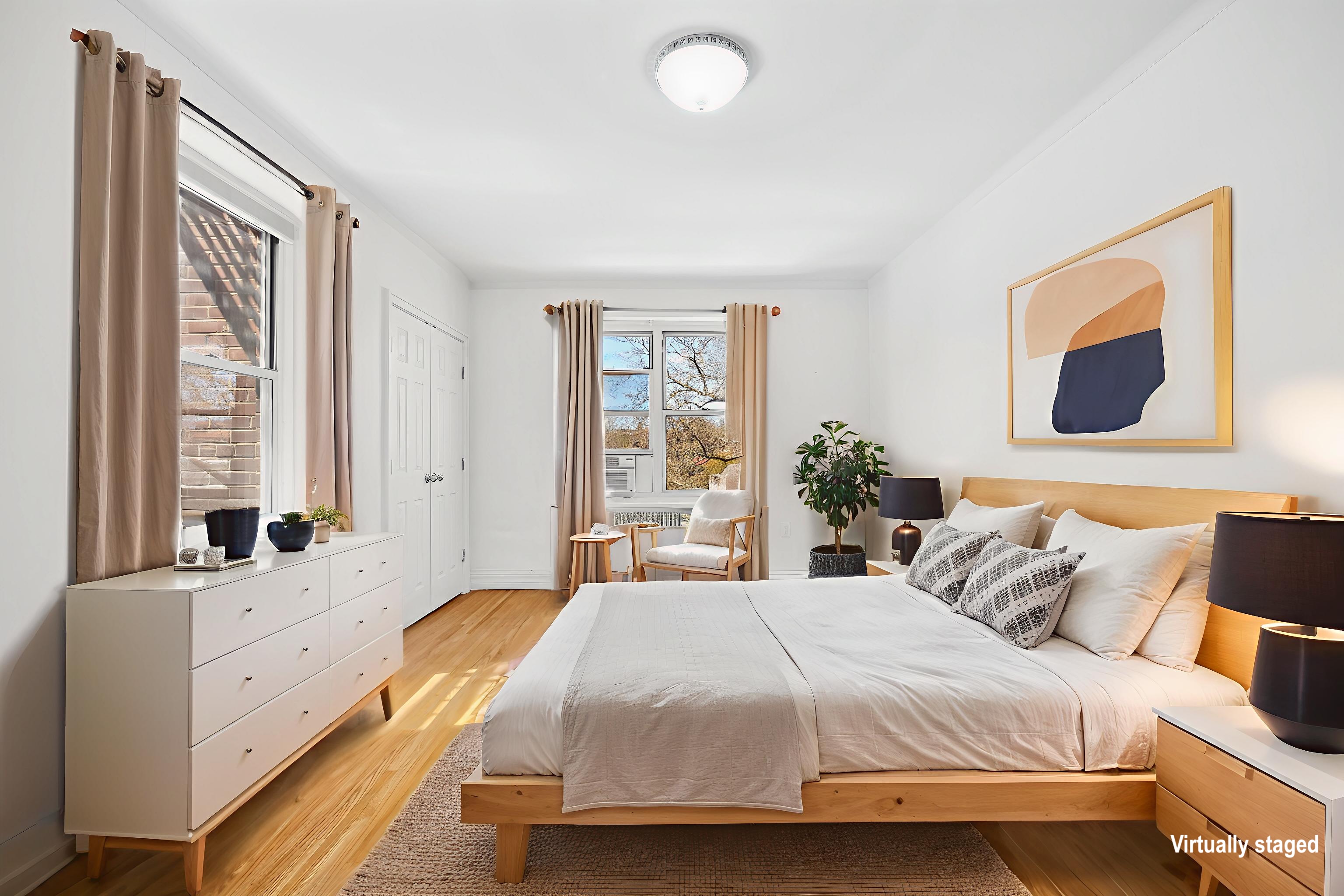 34-41 85th Street, Unit 4R Queens, NY 11372 - Photo 5 of 19 a bedroom with a bed and a large window