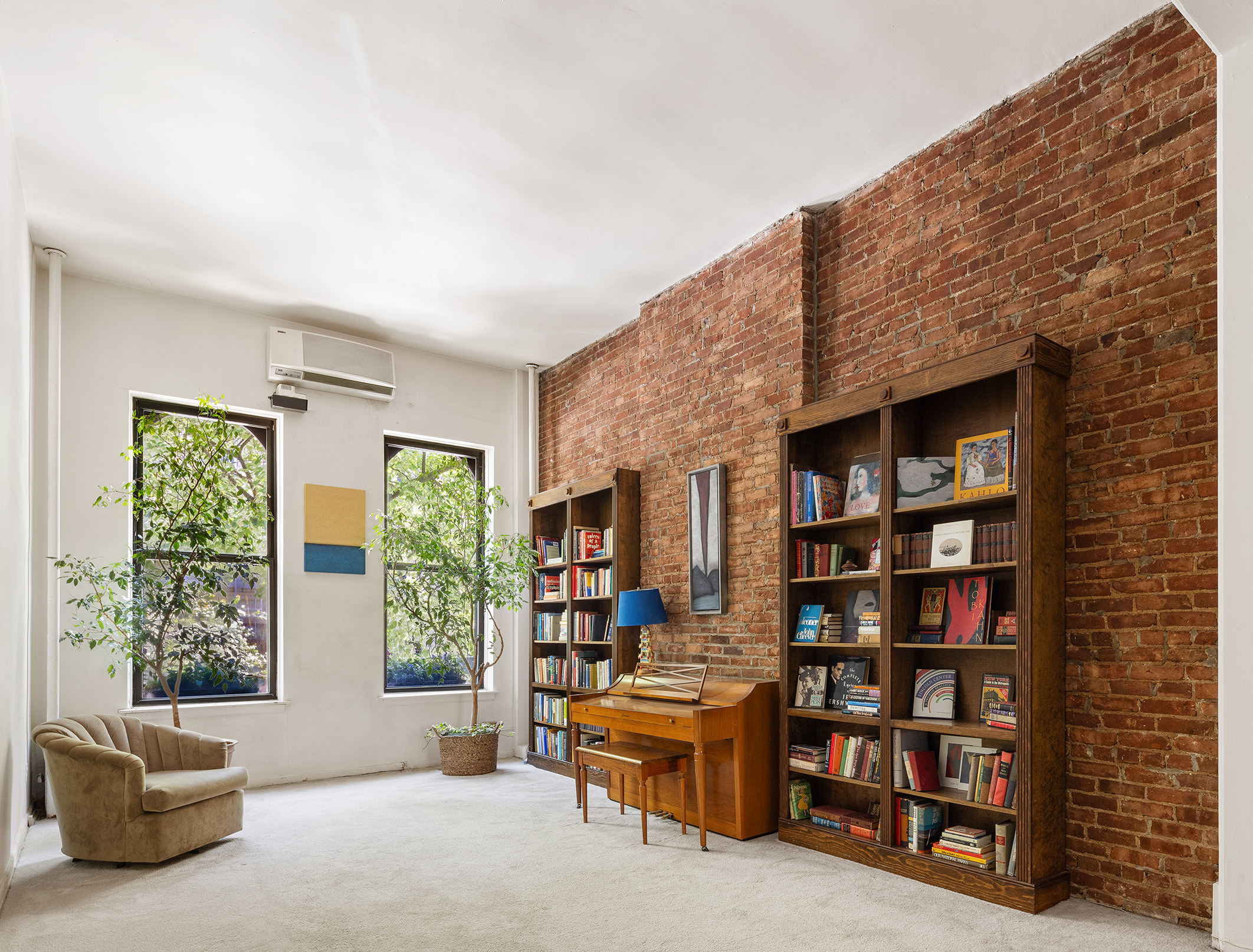 144 West 80th Street Manhattan, NY 10024 - Photo 6 of 22 a living room with furniture and a book shelf