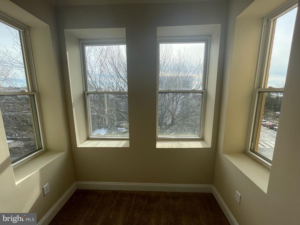 1033 Park Road Northwest, Unit 6 Washington, DC 20010 - Photo 16 of 38 a view of an empty room with wooden floor and a window