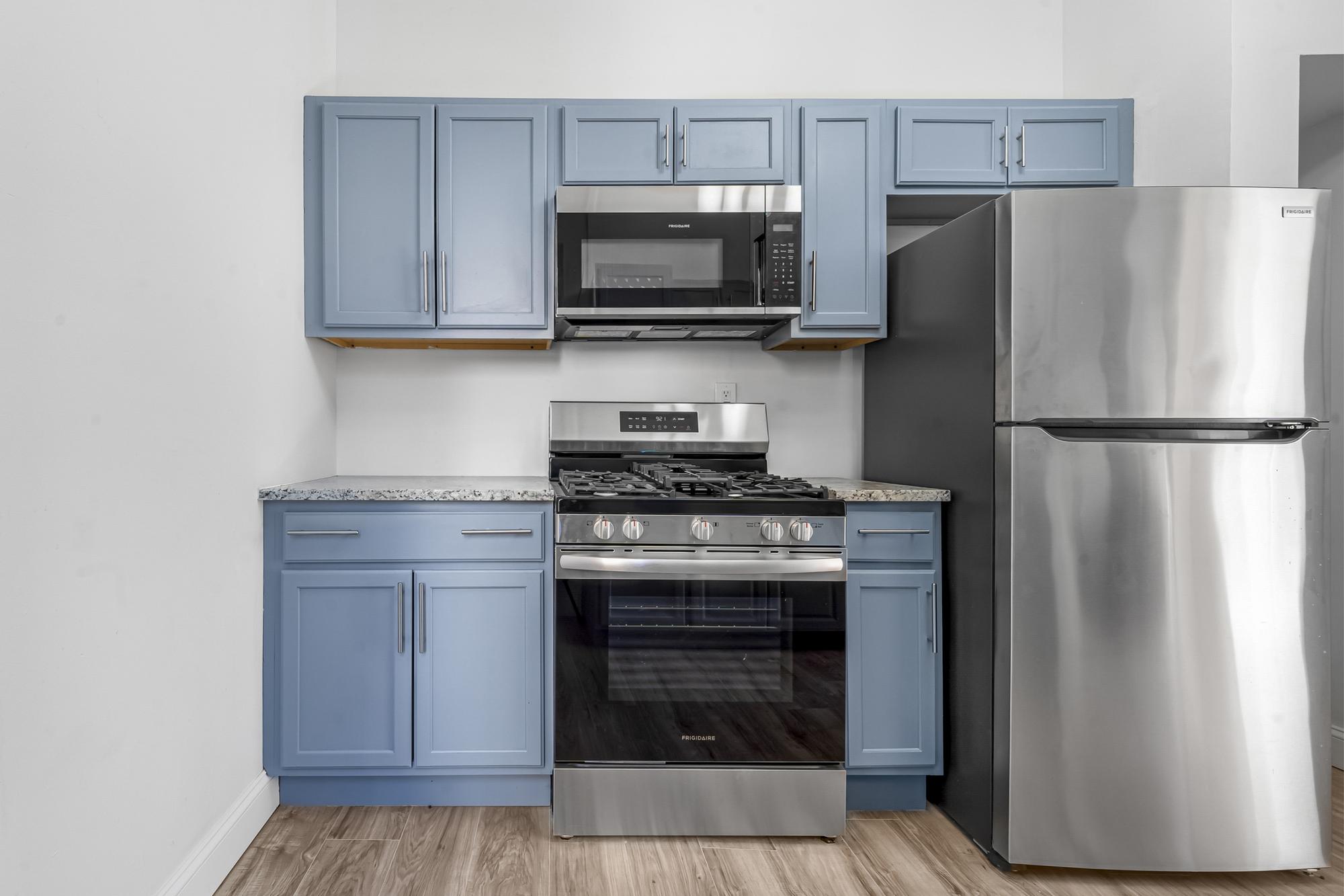 1384 Pacific Street, Unit A2 Brooklyn, NY 11216 - Photo 4 of 16 a kitchen with a stove and a microwave