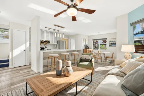 a living room with furniture and a wooden floor