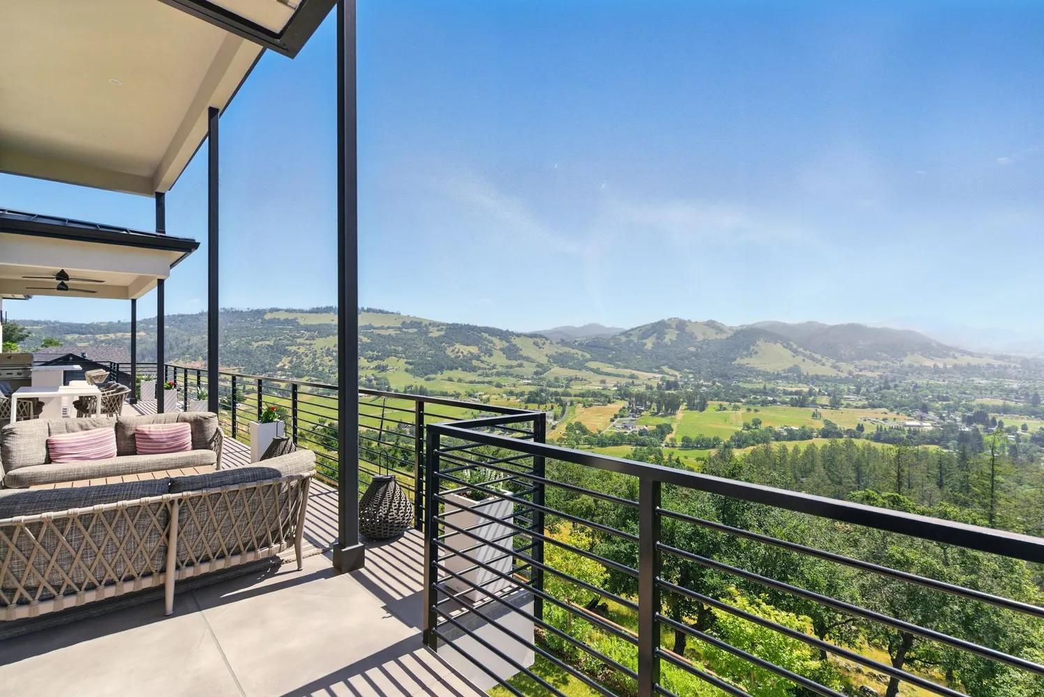 a view of balcony with couches and wooden floor