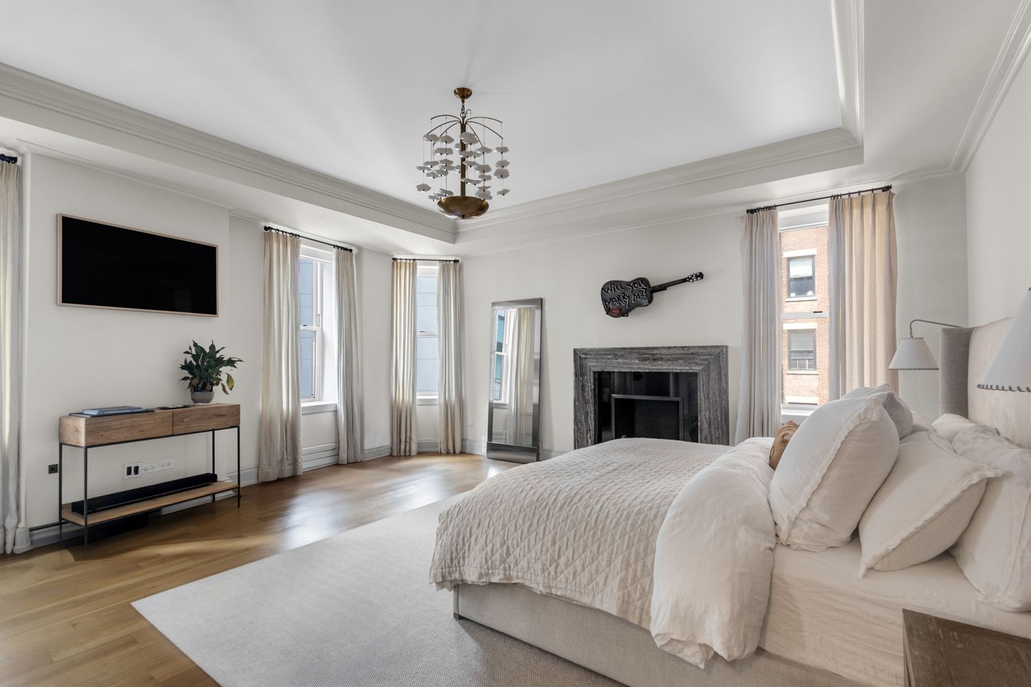 344 West 72nd Street, Unit 1008 Manhattan, NY 10023 - Photo 4 of 35 a spacious bedroom with a bed and a flat screen tv