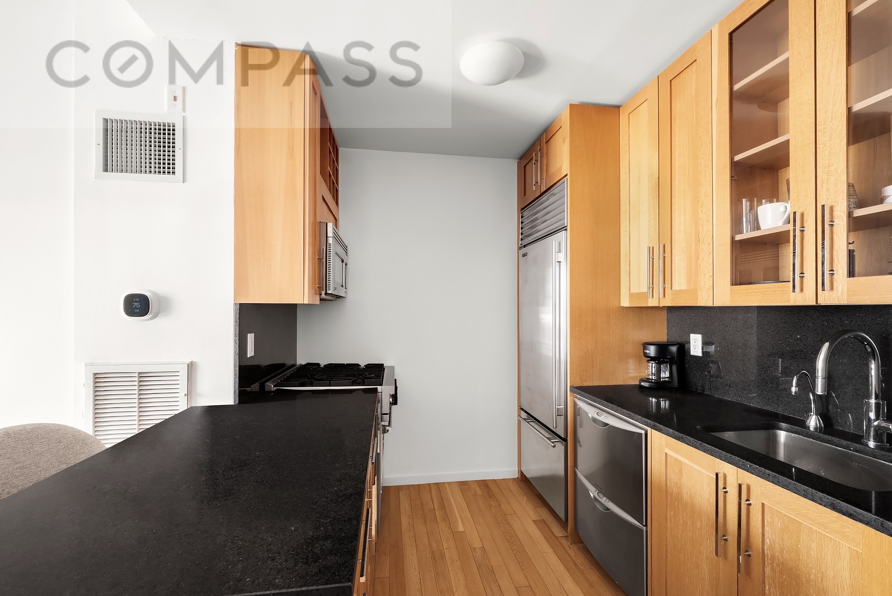 88 Greenwich Street, Unit 2903 Manhattan, NY 10006 - Photo 4 of 13 a kitchen with a sink and a refrigerator