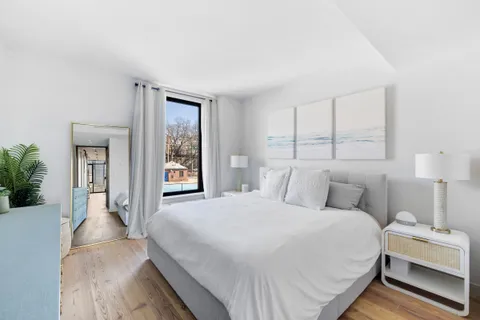 a bedroom with a large bed and a window