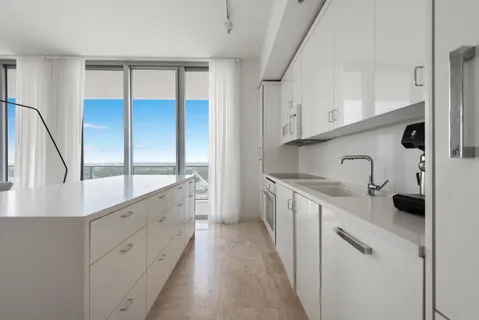 a kitchen with stainless steel appliances a sink stove and cabinets