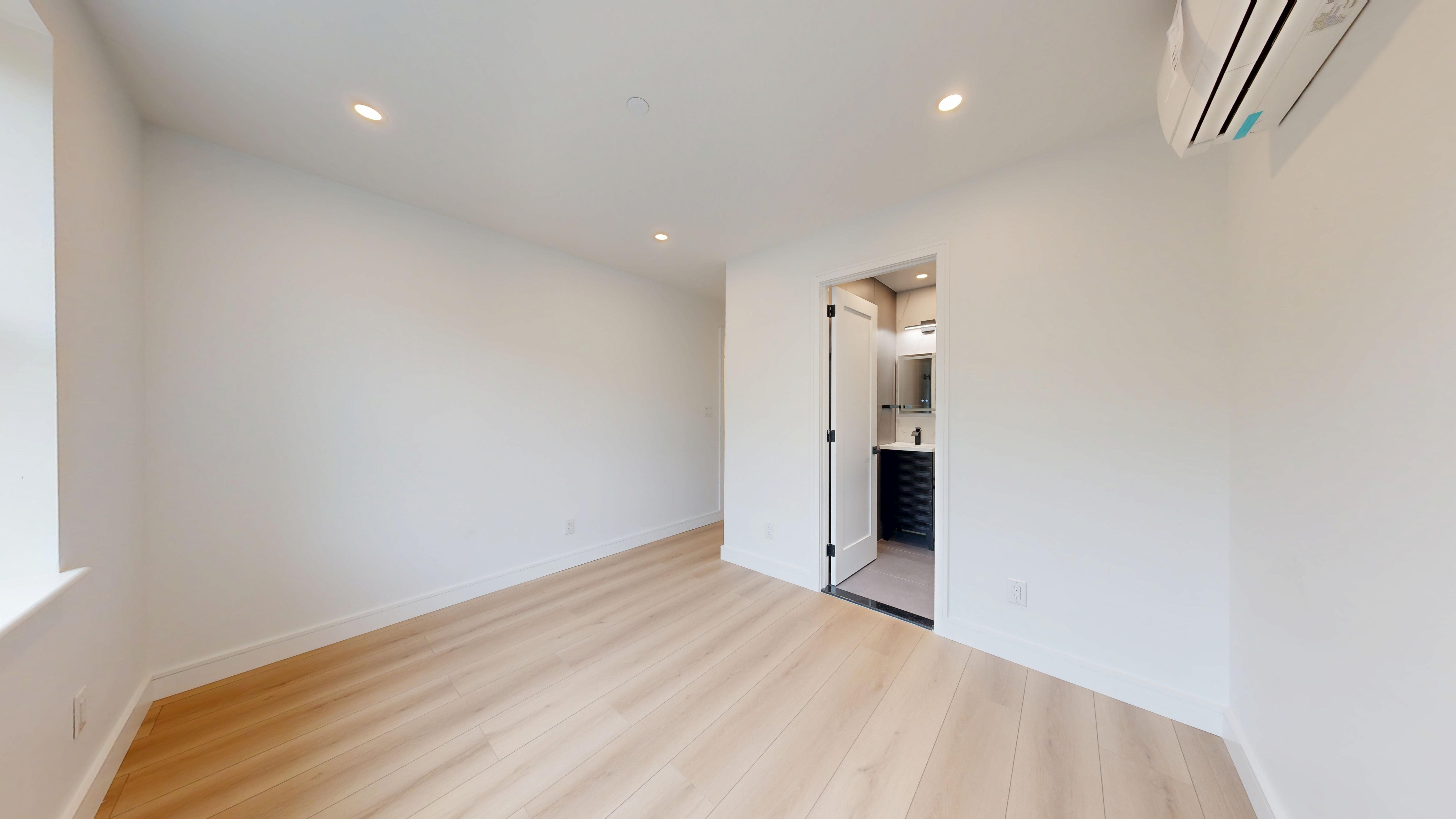 5614 3rd Avenue, Unit 2 Brooklyn, NY 11220 - Photo 11 of 12 a view of a big room with closet and wooden floor