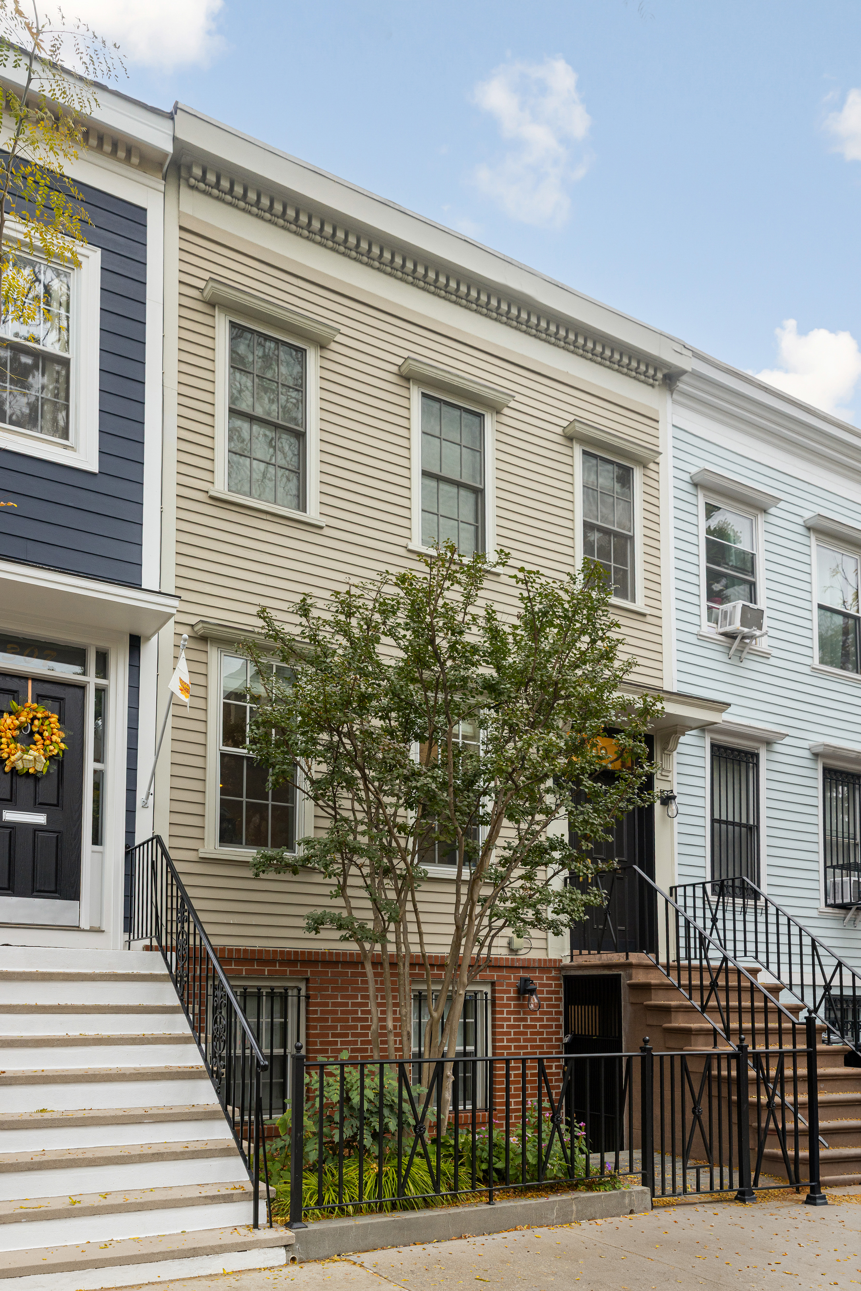 309 Pacific Street Brooklyn, NY 11201 - Photo 21 of 22 a front view of a house with a tree