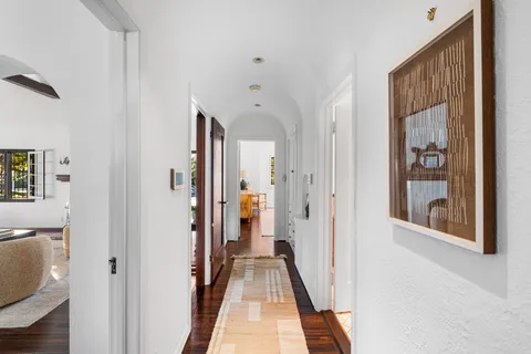 a living room with furniture and a mirror