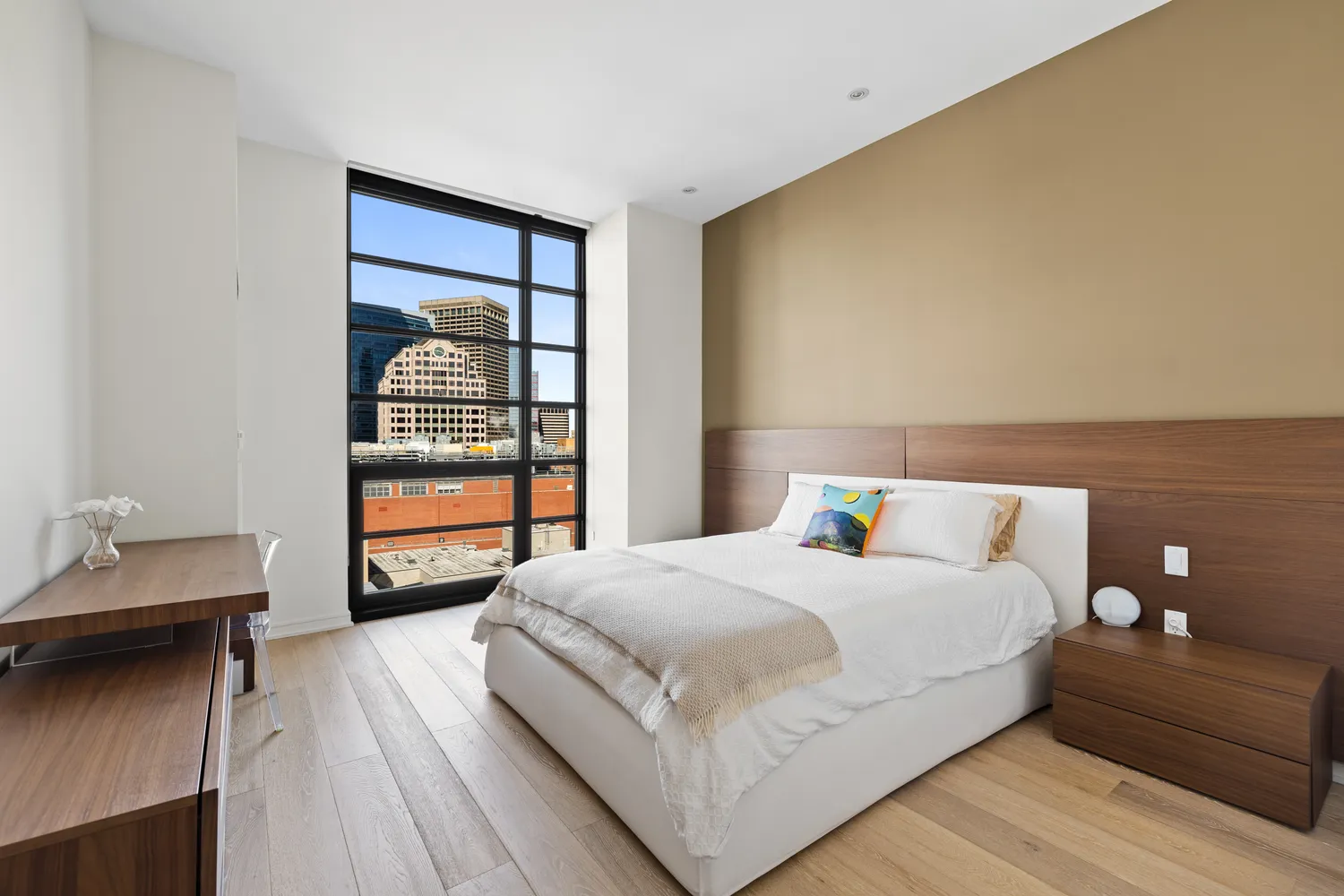 a bedroom with a bed and a night stand