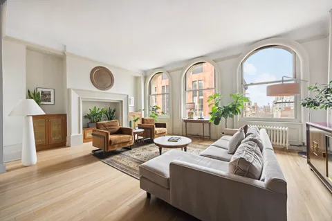 a living room with furniture fireplace and window