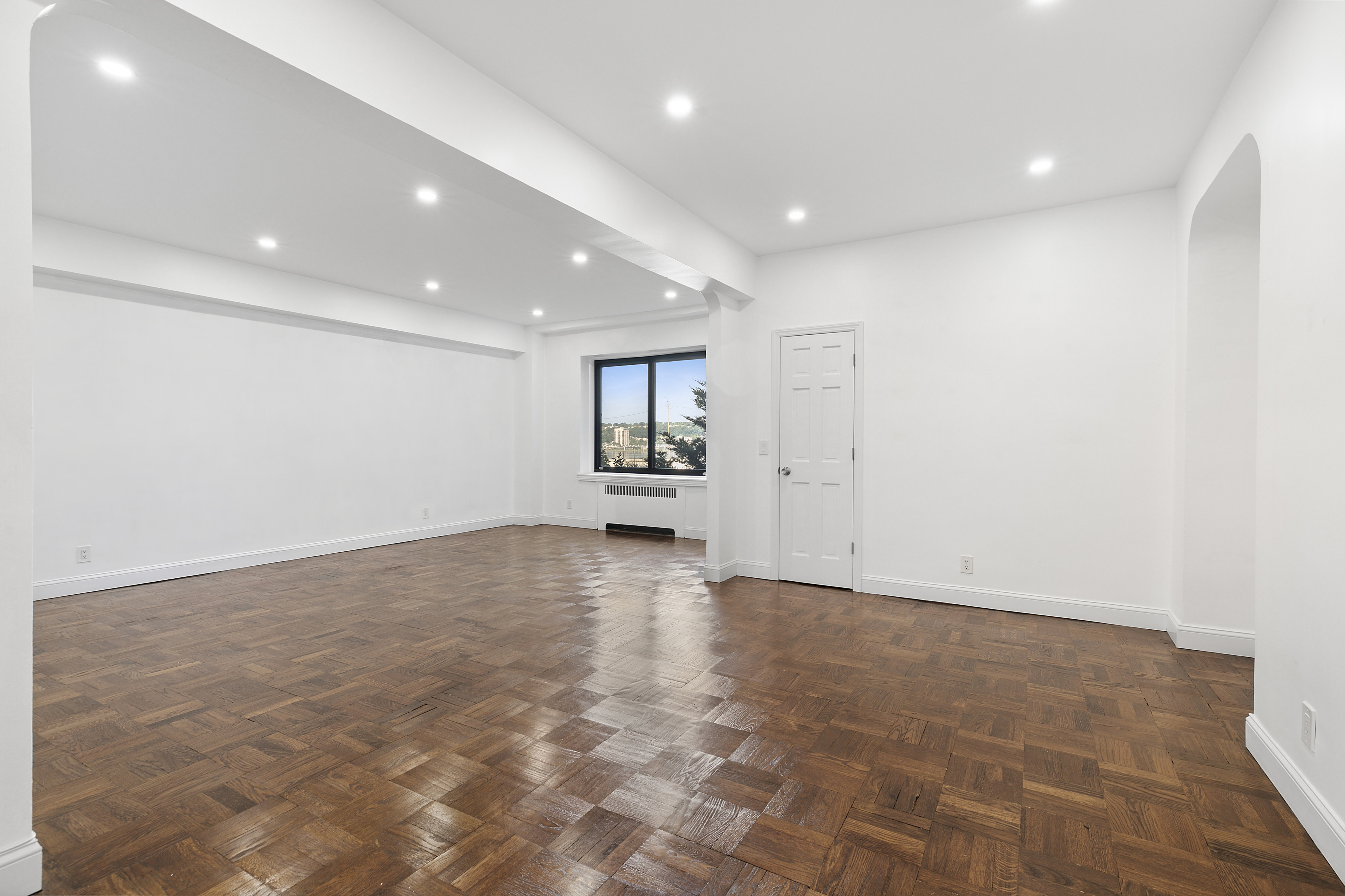 159-34 Riverside Drive West, Unit 1J90 Manhattan, NY 10032 - Photo 2 of 19 an empty room with a empty space and windows