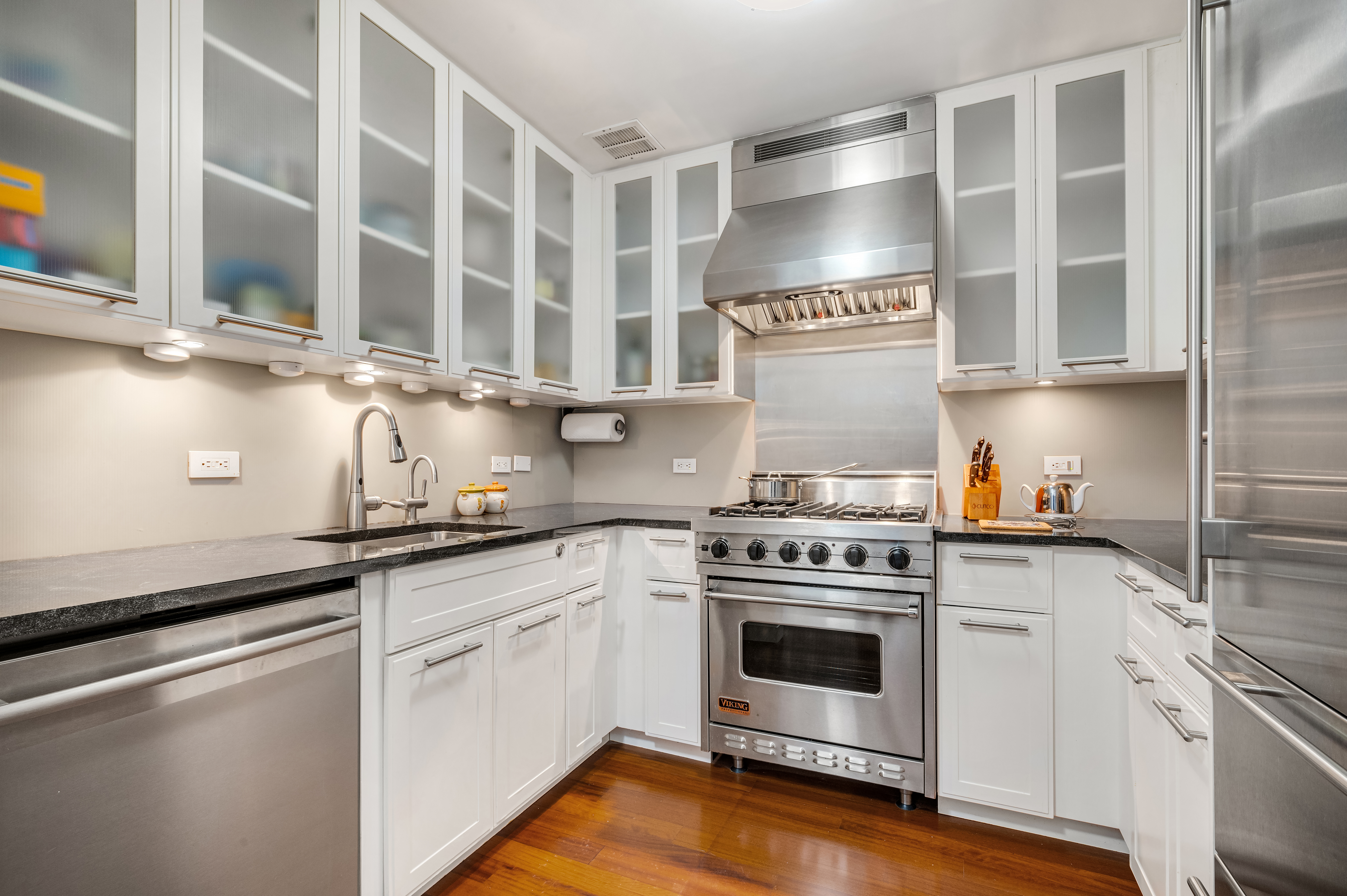 45 Park Avenue, Unit 1801 Manhattan, NY 10016 - Photo 4 of 12 a kitchen with stainless steel appliances a stove and white cabinets