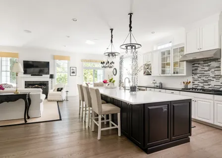 a kitchen with center island table and chairs