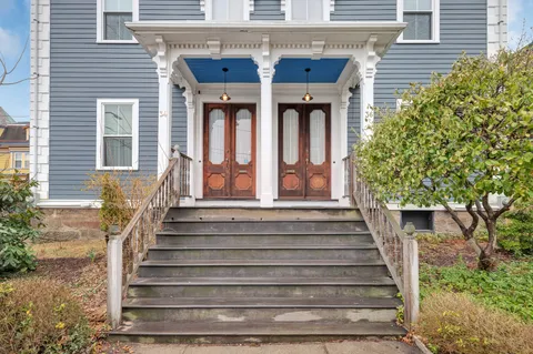a view of a building with entryway and plants