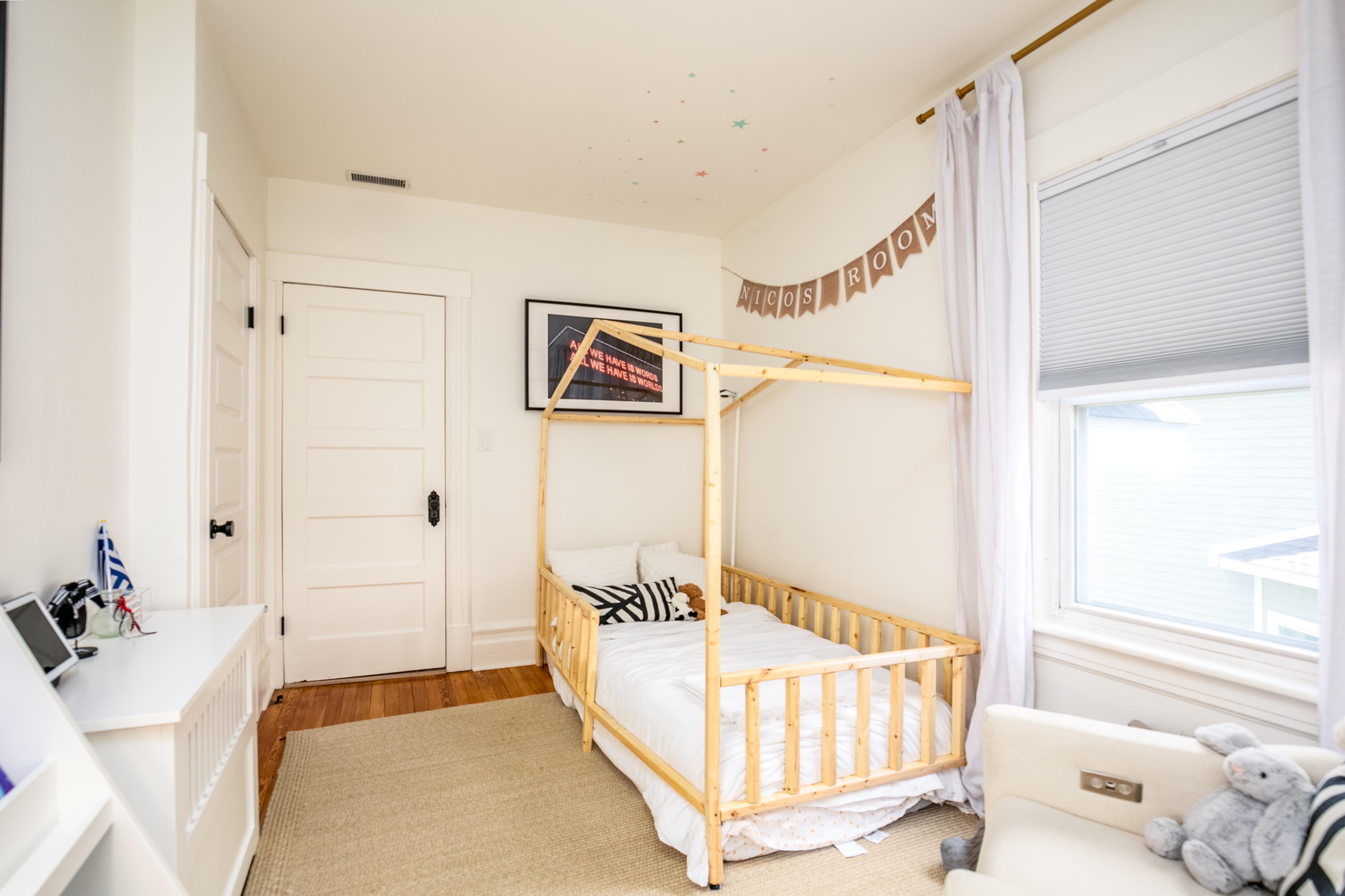 163 Ridge Road Rutherford, NJ 07070 - Photo 28 of 59 a spacious bedroom with a bed and a window