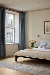 a bedroom with a bed and window