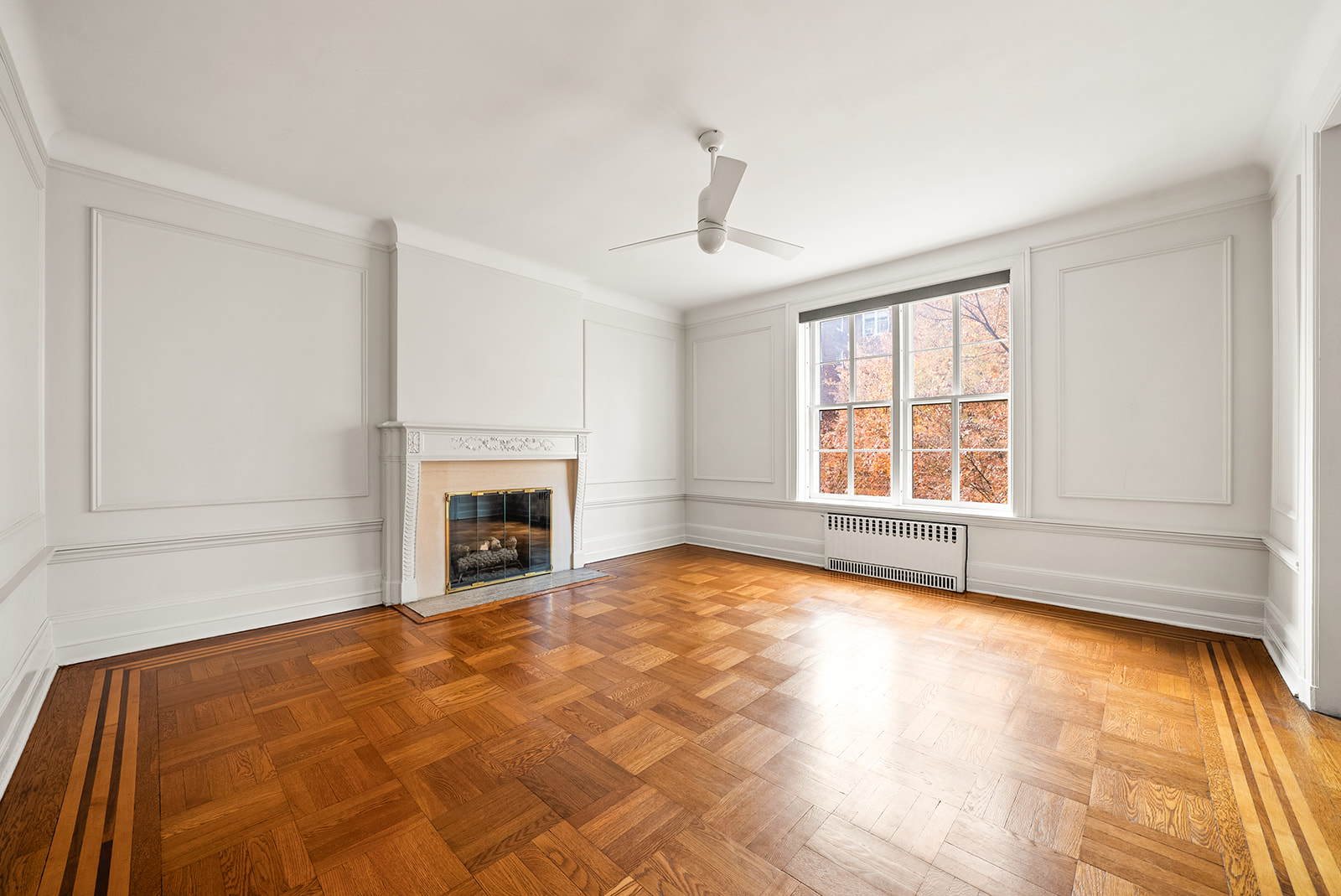 34-13 80th Street, Unit 31 Queens, NY 11372 - Photo 3 of 16 a view of an empty room with a fireplace and a window