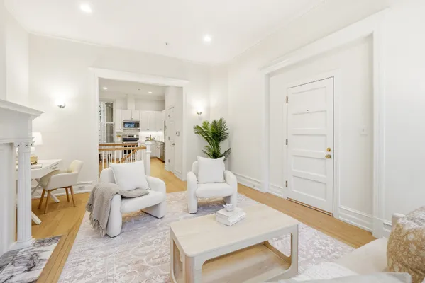 a living room with furniture a rug and white walls
