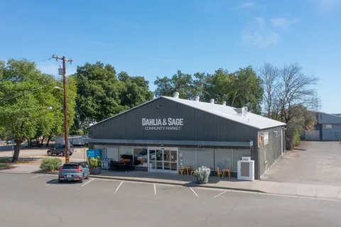 a front view of a building with parked cars
