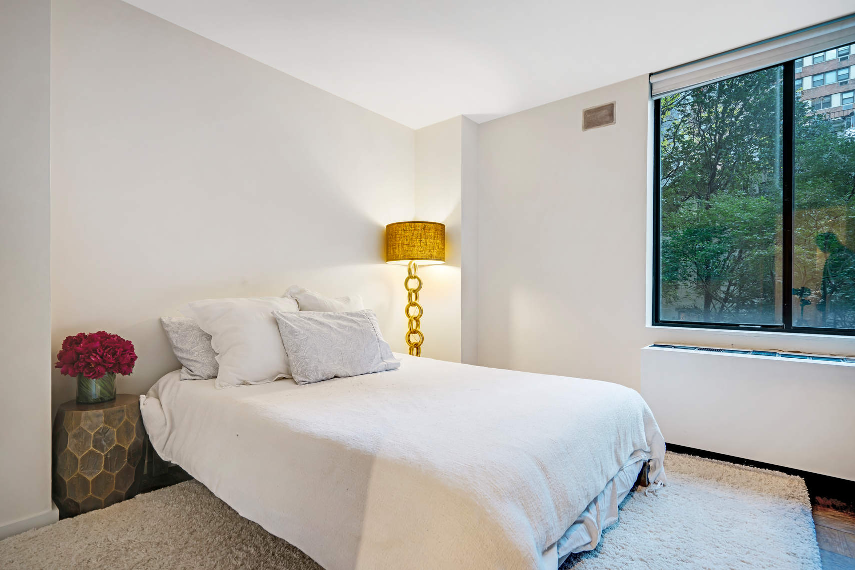 309 East 49th Street, Unit 2B3B Manhattan, NY 10017 - Photo 12 of 16 a bedroom with a bed and window