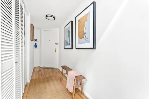 a view of a bedroom with bed and wooden floor