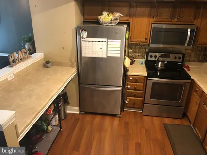 a kitchen with appliances and cabinets
