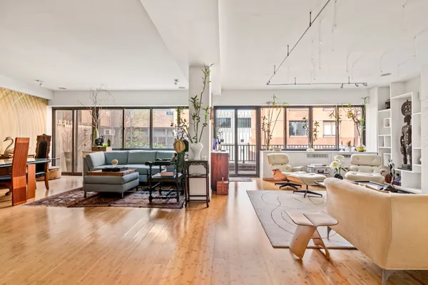 a living room with furniture and large windows