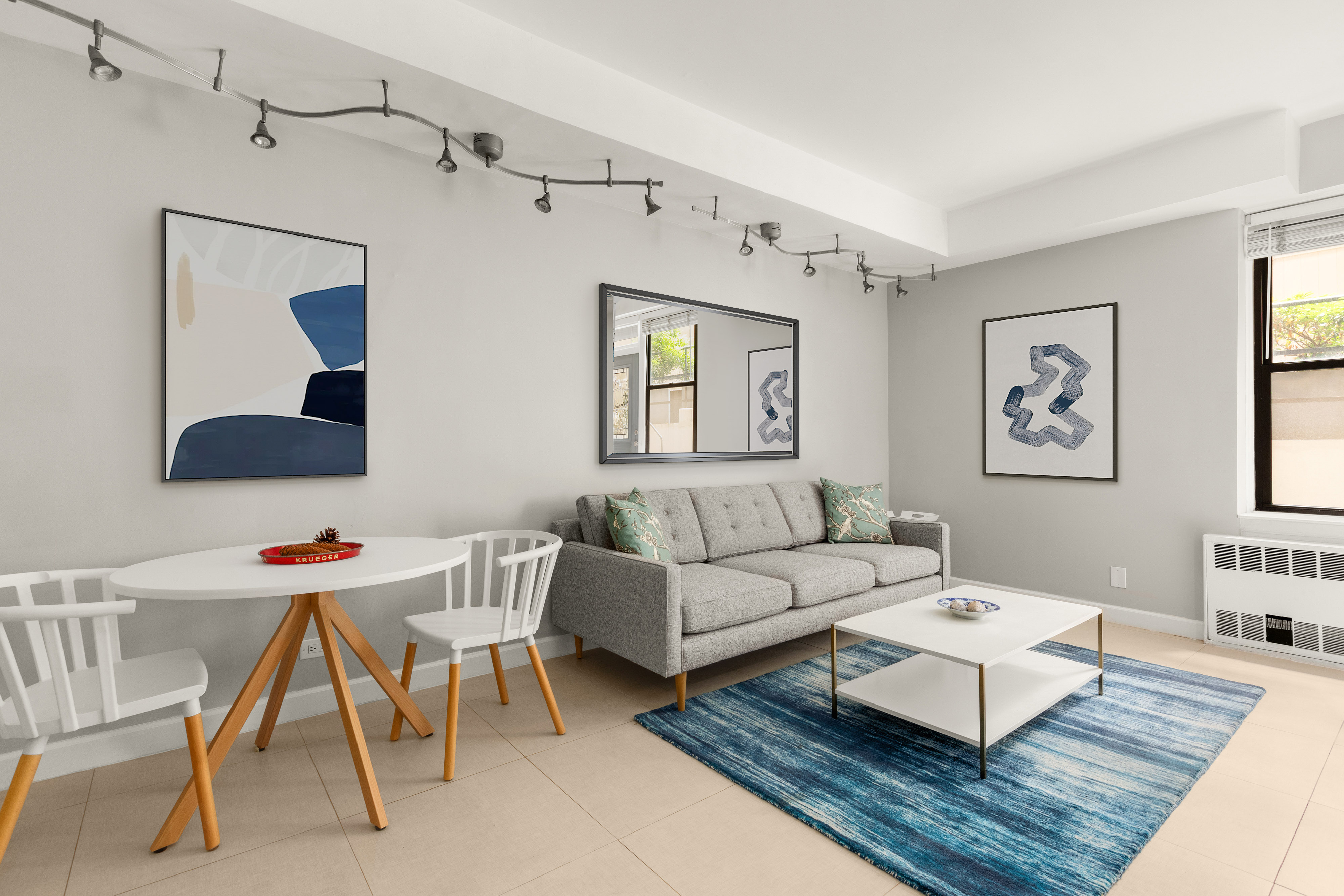 342 East 53rd Street, Unit 1G Manhattan, NY 10022 - Photo 2 of 9 a living room with furniture and a painting on the wall