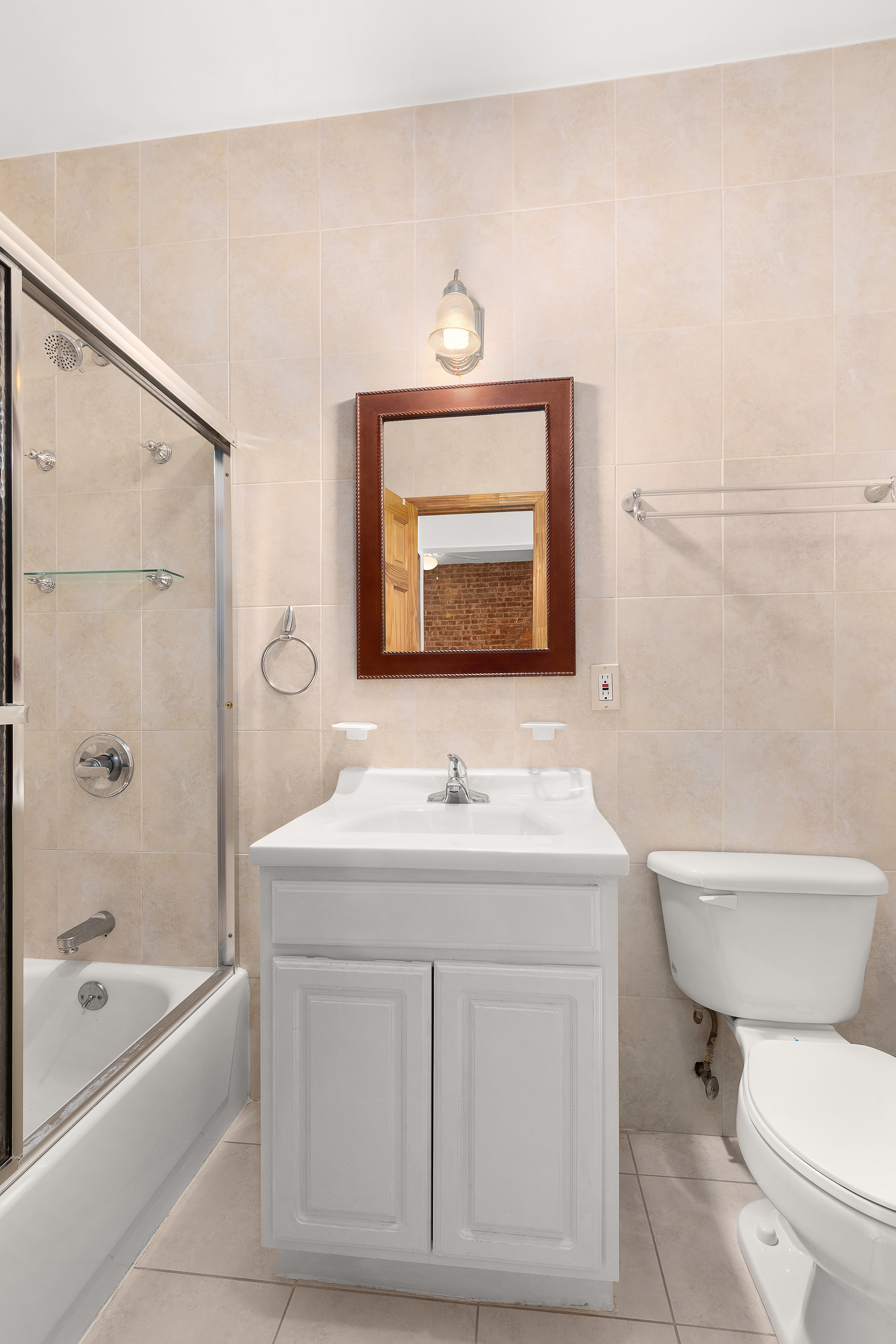 11-51 44th Drive, Unit 2 Queens, NY 11101 - Photo 4 of 6 a bathroom with a sink toilet vanity and bathtub