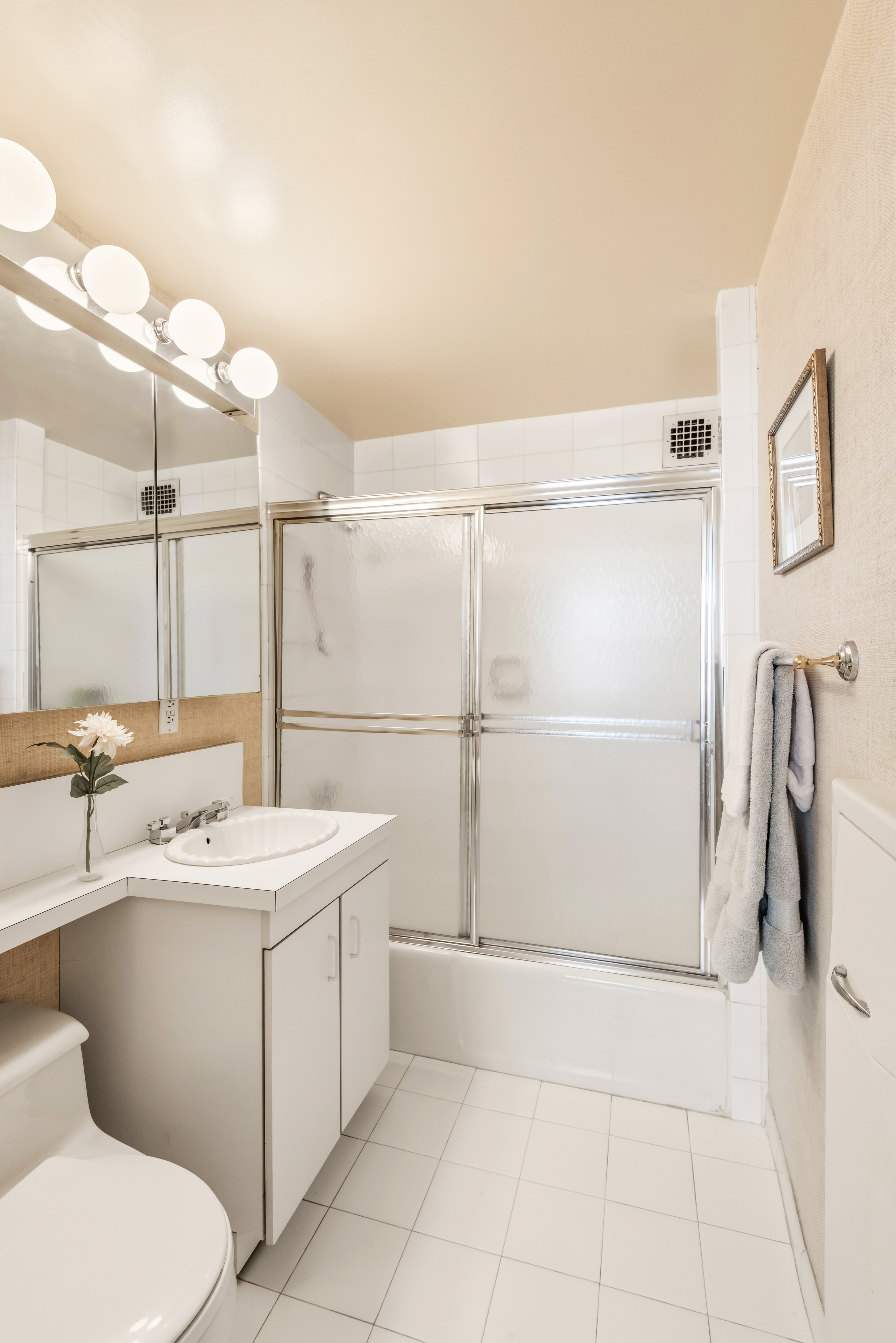 175 East 62nd Street, Unit 14B Manhattan, NY 10065 - Photo 11 of 12 a bathroom with a sink a toilet and shower