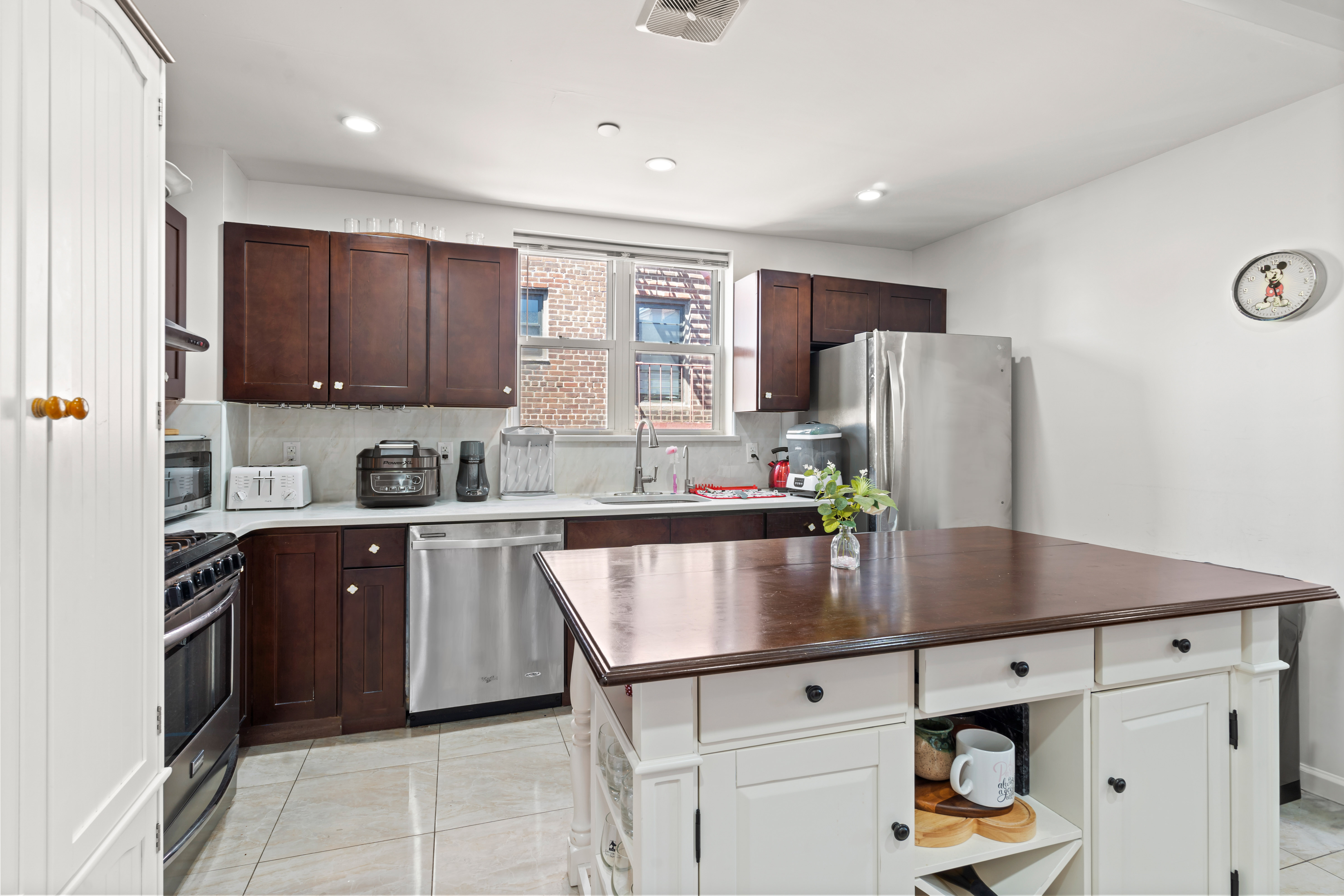 65-33 38th Avenue, Unit 5 Queens, NY 11377 - Photo 6 of 23 a kitchen with stainless steel appliances granite countertop a refrigerator a sink dishwasher a stove and a refrigerator