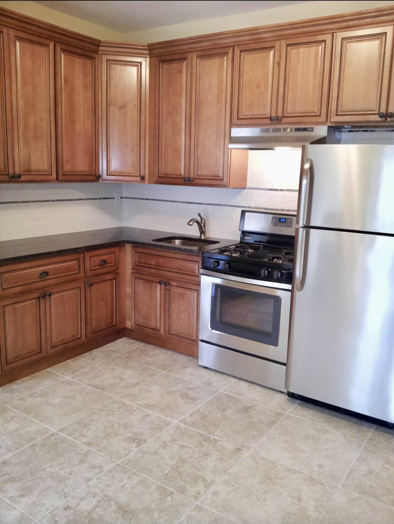 3194 Webster Avenue Bronx, NY 10467 - Photo 13 of 23 a kitchen with granite countertop a stove top oven sink and cabinets